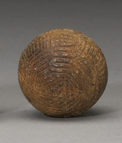 A hand-hammered gutta-percha golf ball circa 1870s