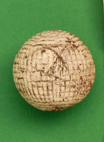 A hand hammered gutty golf ball